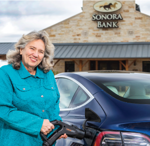 Female customer using car charging station